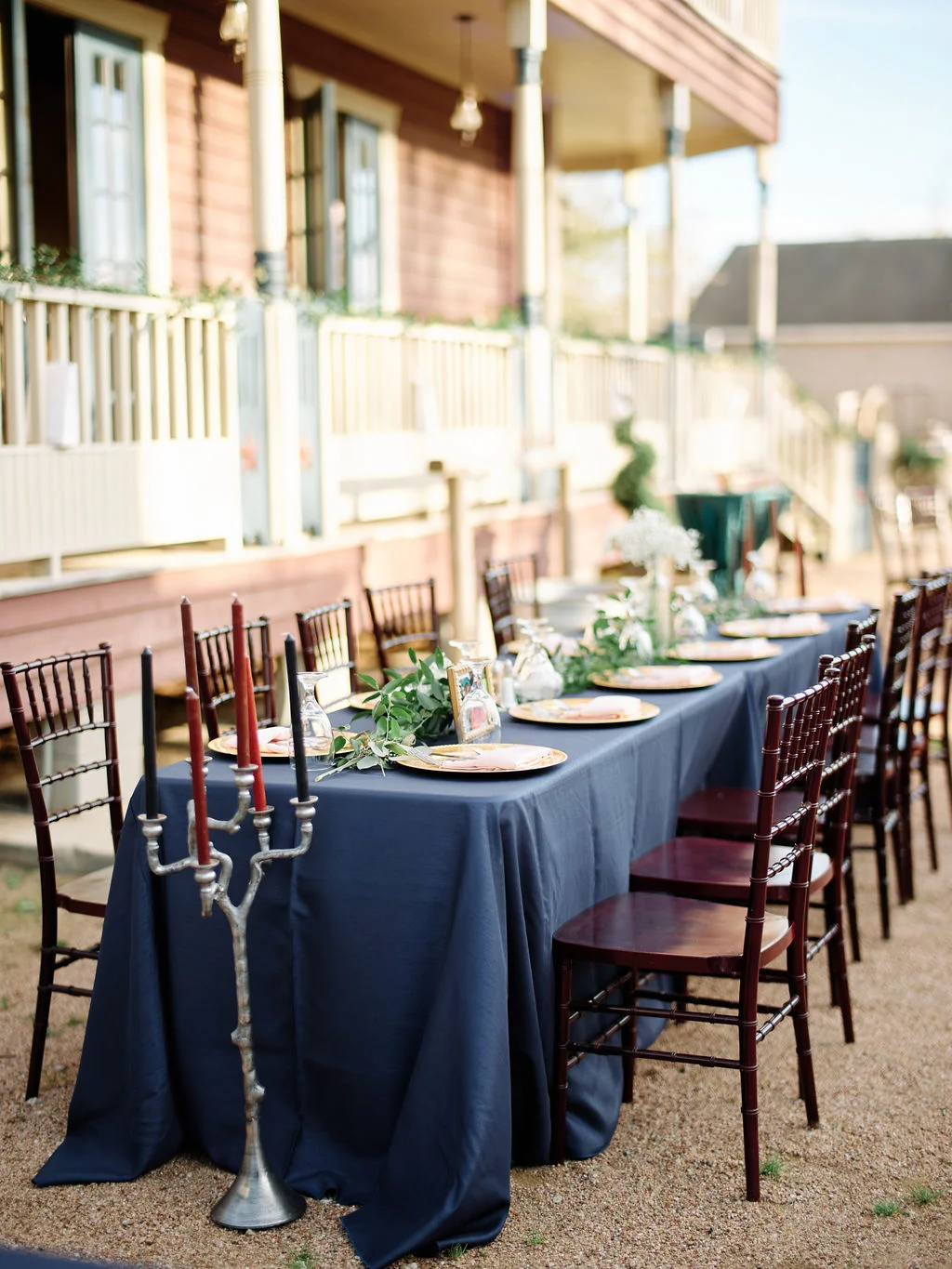 Reception table with jewel-tone linens and candelabra