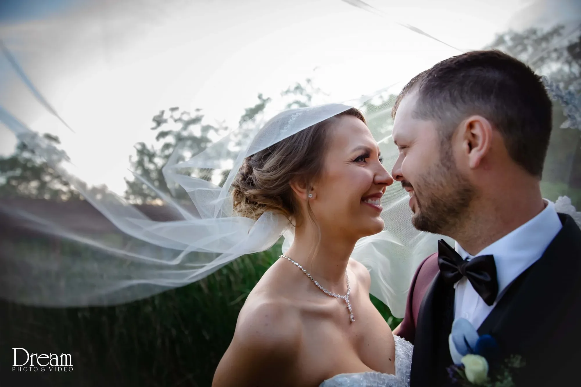 Couple portrait with veil in the breeze